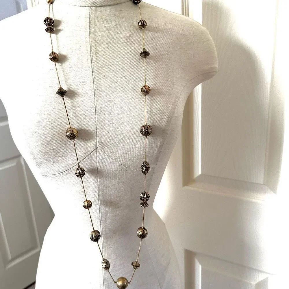 Long gold tone beaded necklace